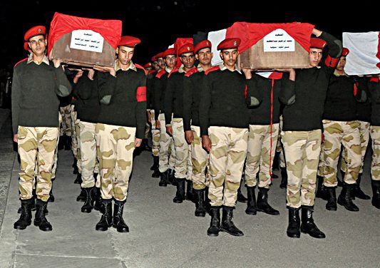 Coffins of Egyptian soldiers killed in Sinai arrive at military airport in Cairo
