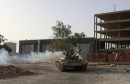 Fighters from the Benghazi Shura Council ride on top of a tank in Benghazi