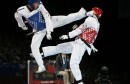 Turkey's Servet Tazegul kicks Britain's Martin Stamper during their men's -68kg semifinal taekwondo match at the London Olympic Games