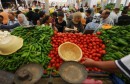 Tunisian shoppers browse vegetables disp