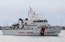 Migrants stand on the "Fiorillo" Coast Guard vessel as they arrive at the Porto Empedocle harbour