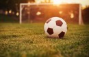 soccer-ball-on-field-near-against-setting-sun