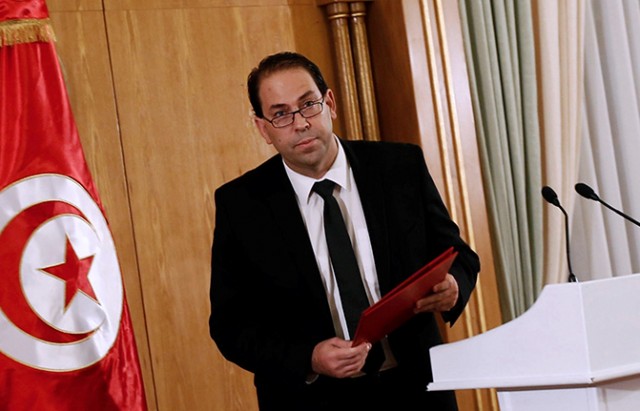 Tunisia's Prime Minister-designate Youssef Chahed leaves after a news conference in Tunis