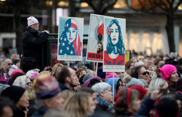 Protesters carrying banners and placards take part in a Women's March in Stockholm,   Sweden
