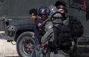 Israeli border police detains a Palestinian at Qalandia checkpoint, near the West Bank city of Ramallah
