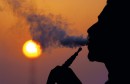 Lebanese man smokes water pipe at sunset in Beirut