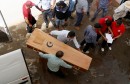 Relatives carry a coffin containing the body of an immigrant who drowned when a boat sank, at a hospital morgue in Sfax