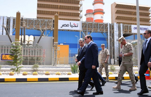Egyptian President Abdel Fattah Al Sisi walks with Egypt's Electricity Minister Mohamed Shaker during the inauguration of major power stations in the energy sector, at Egypt's new administrative capital