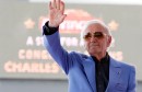 FILE PHOTO: Armenian-French singer Aznavour waves before unveiling his star on the Hollywood Walk of Fame in Los Angeles
