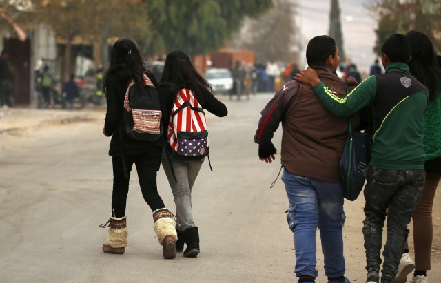 Students walks to their houses at the impoverished Zhor neighborhood of Kasserine