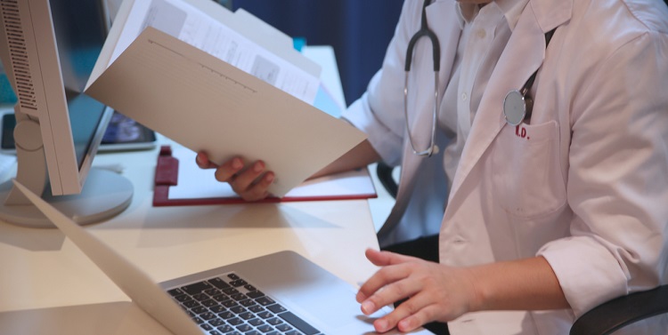 Japanese male doctor checking documents