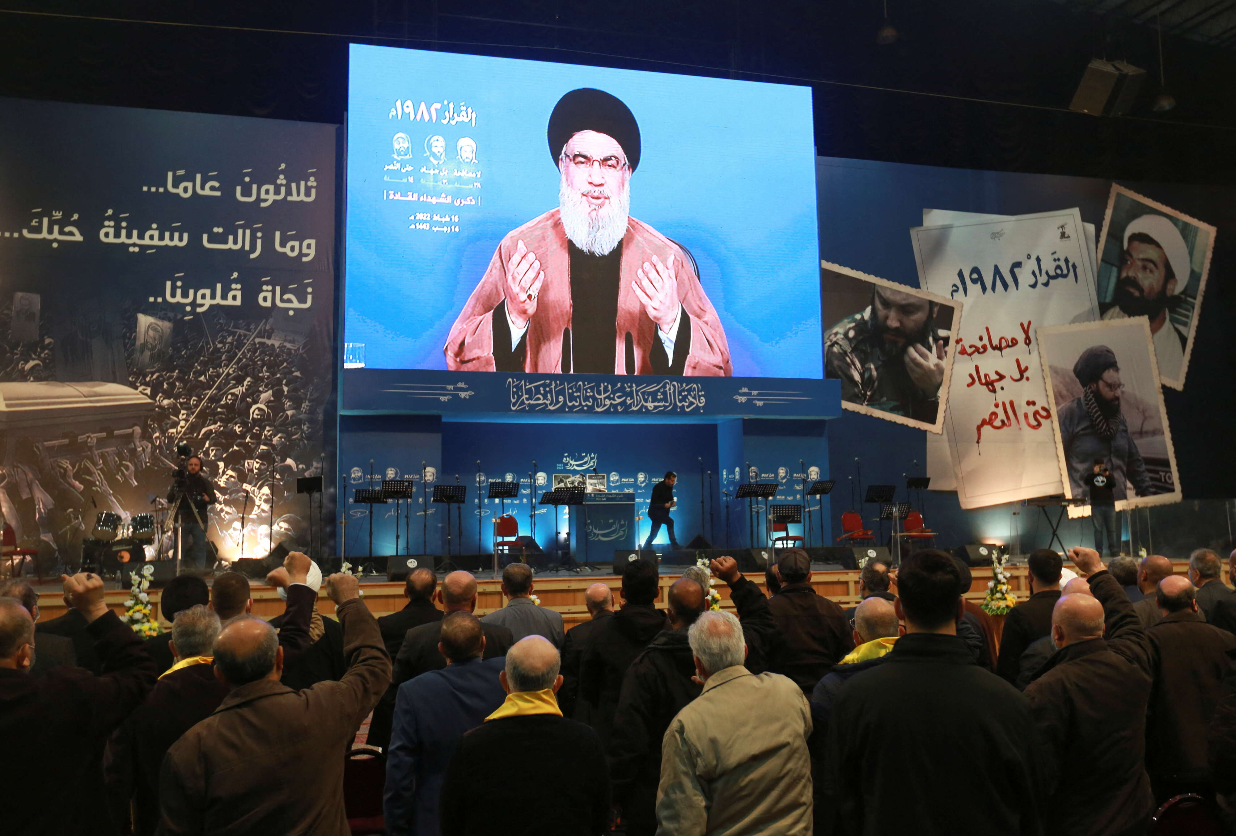 Lebanon's Hezbollah leader Sayyed Hassan Nasrallah addresses his supporters on screen during a rally commemorating the group's late leaders in Beirut