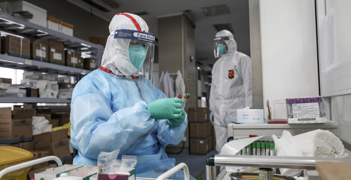 Medical worker in protective suit prepares for an RNA test at Jinyintan hospital in Wuhan, the epicentre of the novel coronavirus outbreak