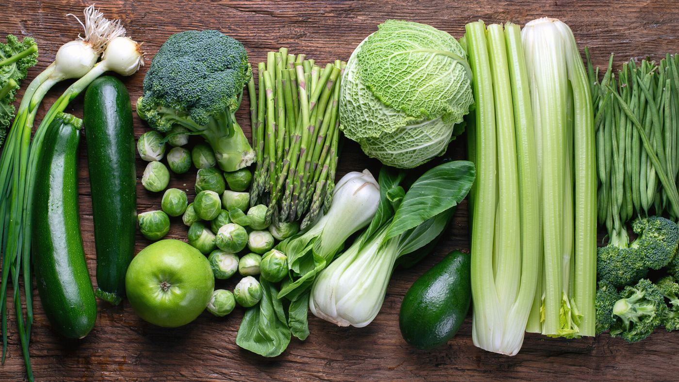 Fresh green vegetables on wooden table. Top view. Flat lay