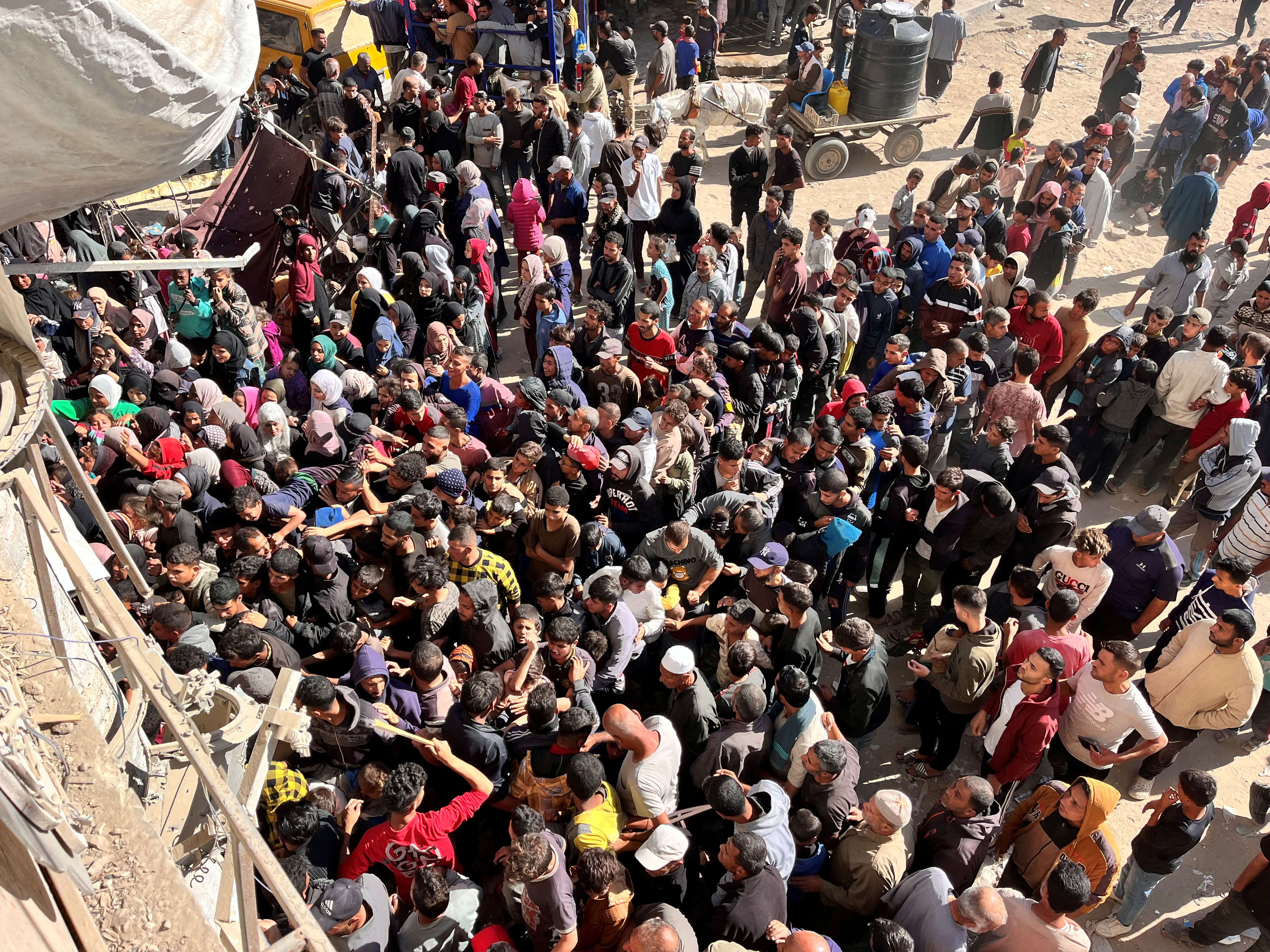 Palestinians gather to buy bread from a bakery, in Khan Younis, in the southern Gaza Strip